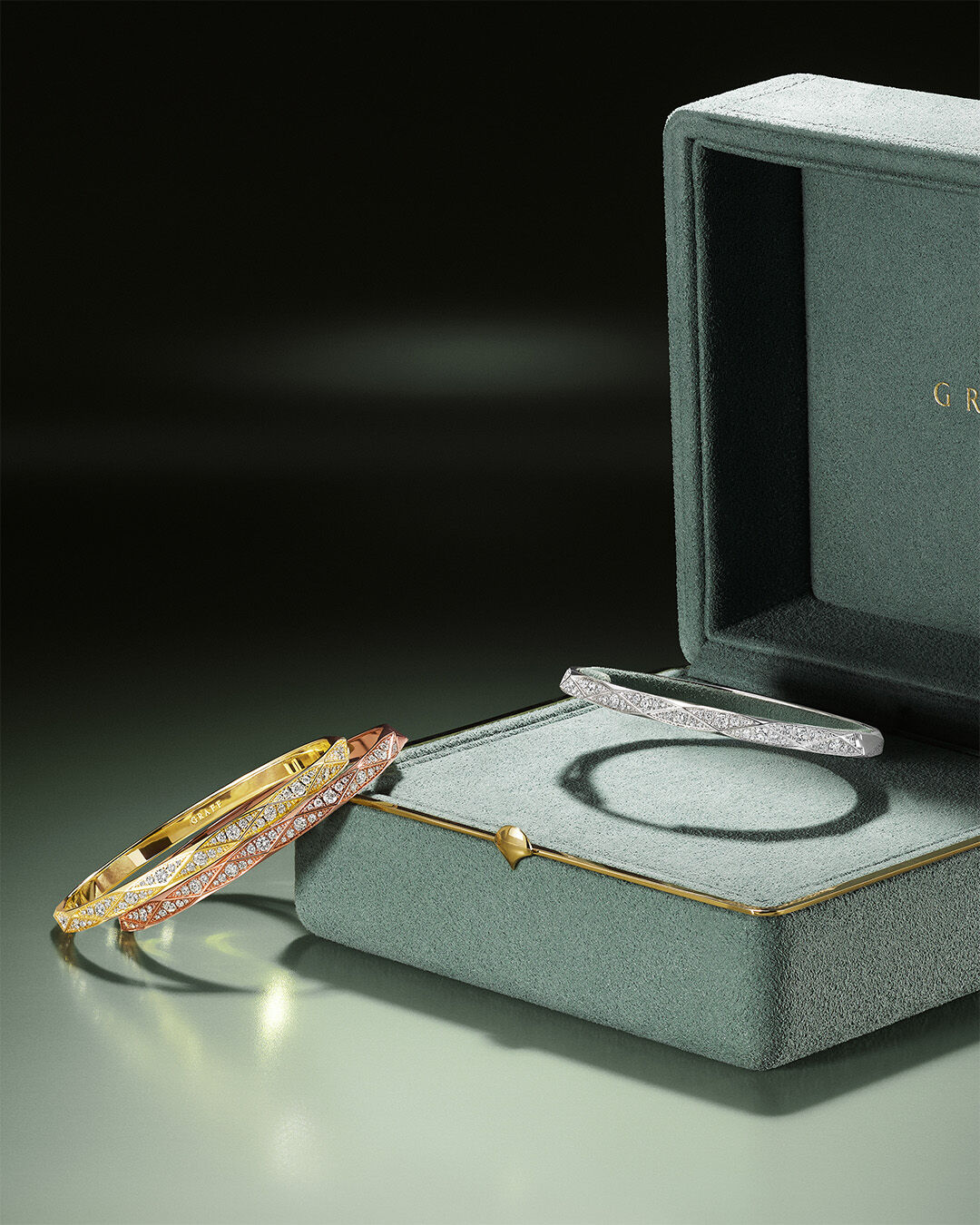 Image shows Laurence Graff Signature Diamond bangle in and next to Graff gift box