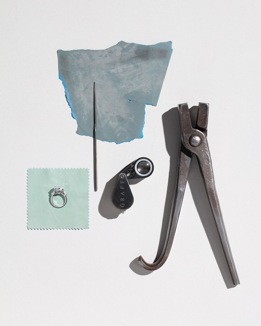 A Guide to Diamond Certification - image shows Graff engagement ring and workshop tools