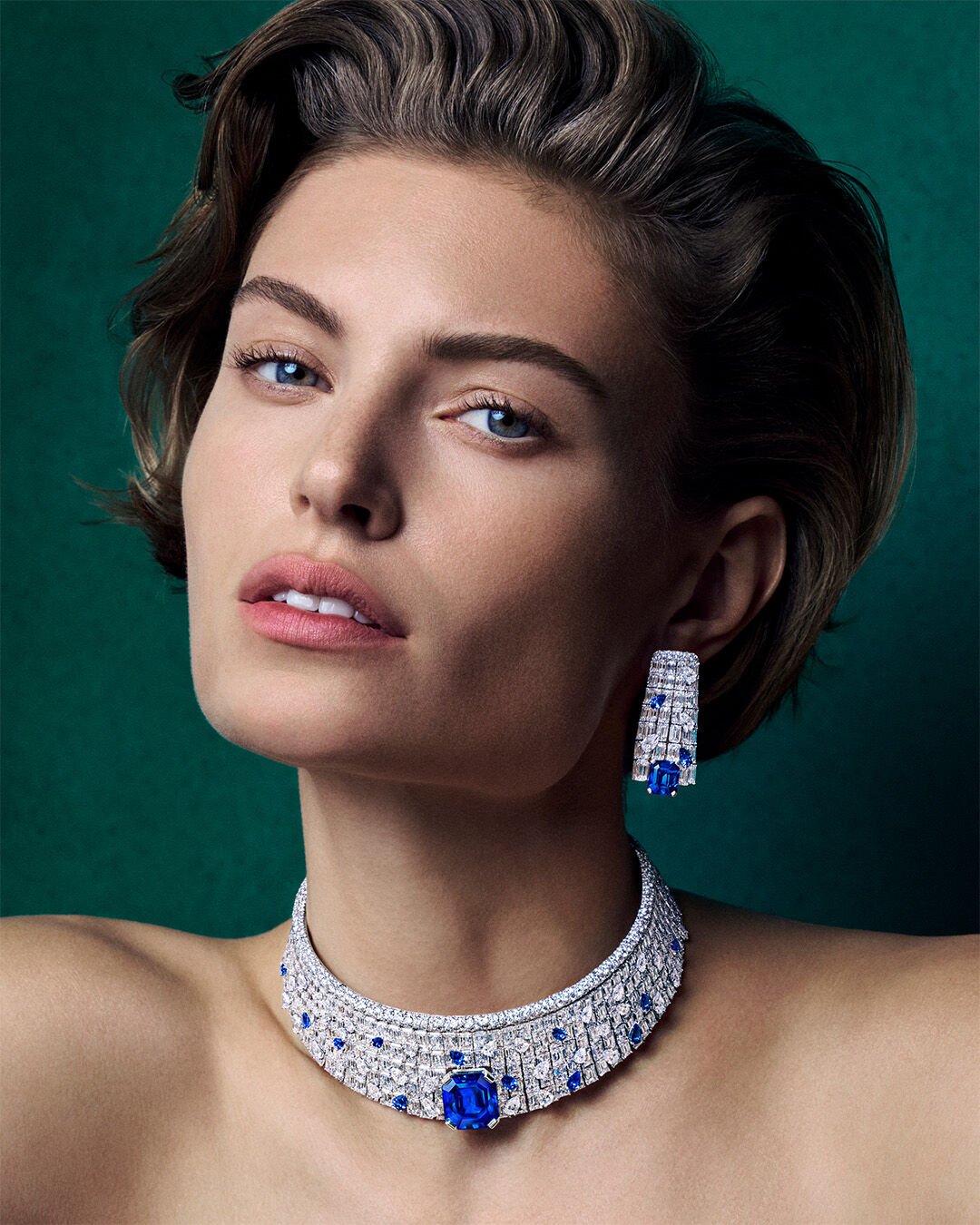 Image shows model wearing Graff high jewellery sapphire and white diamond suite