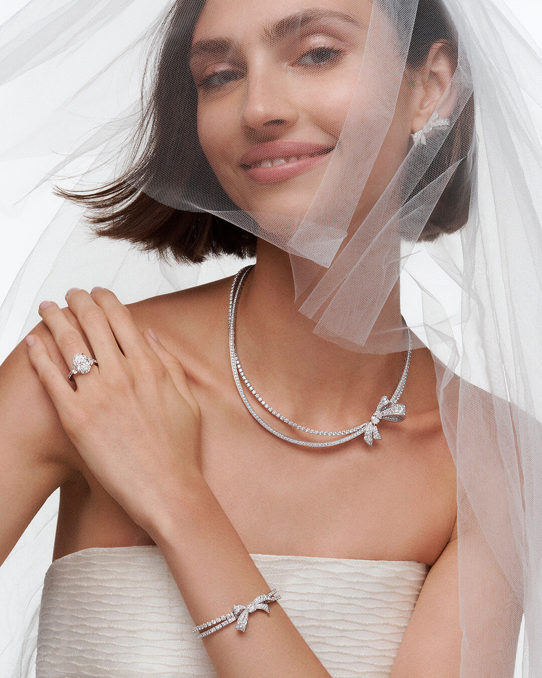 Image shows model wearing Graff White Diamond High Jewellery earrings and necklace