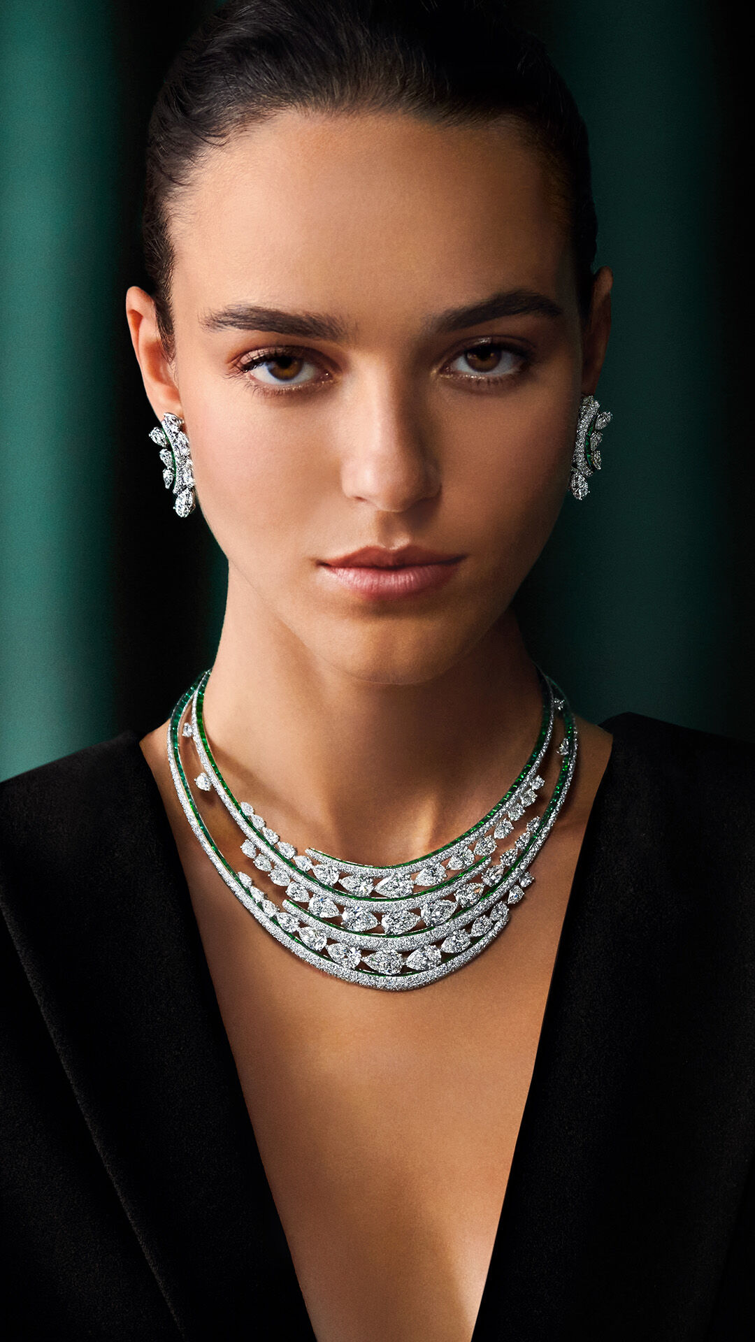 Image shows model wearing Graff White Diamond and Emerald Earrings and Necklace