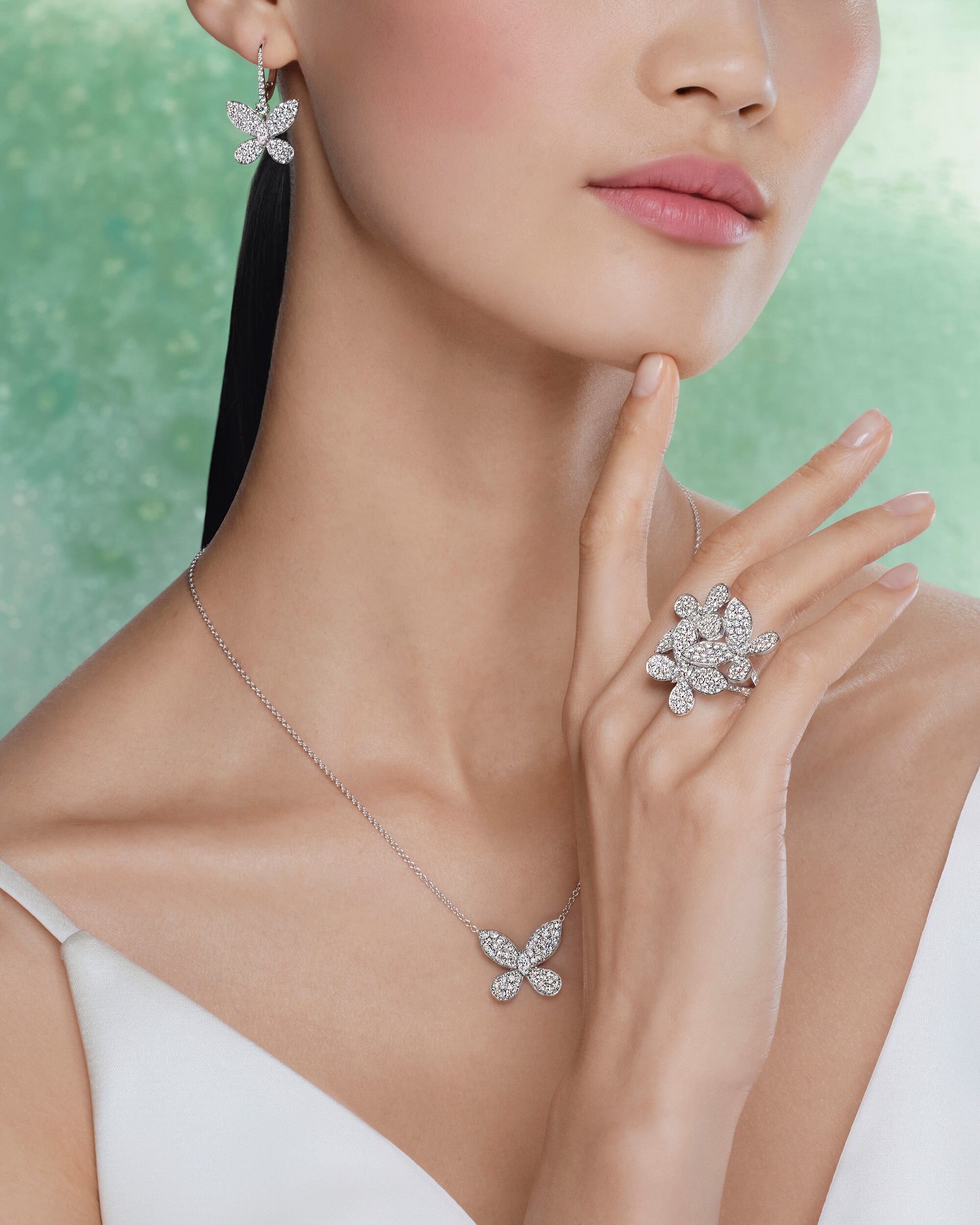 Image shows model wearing Graff Butterfly Classic diamond earrings and ring 