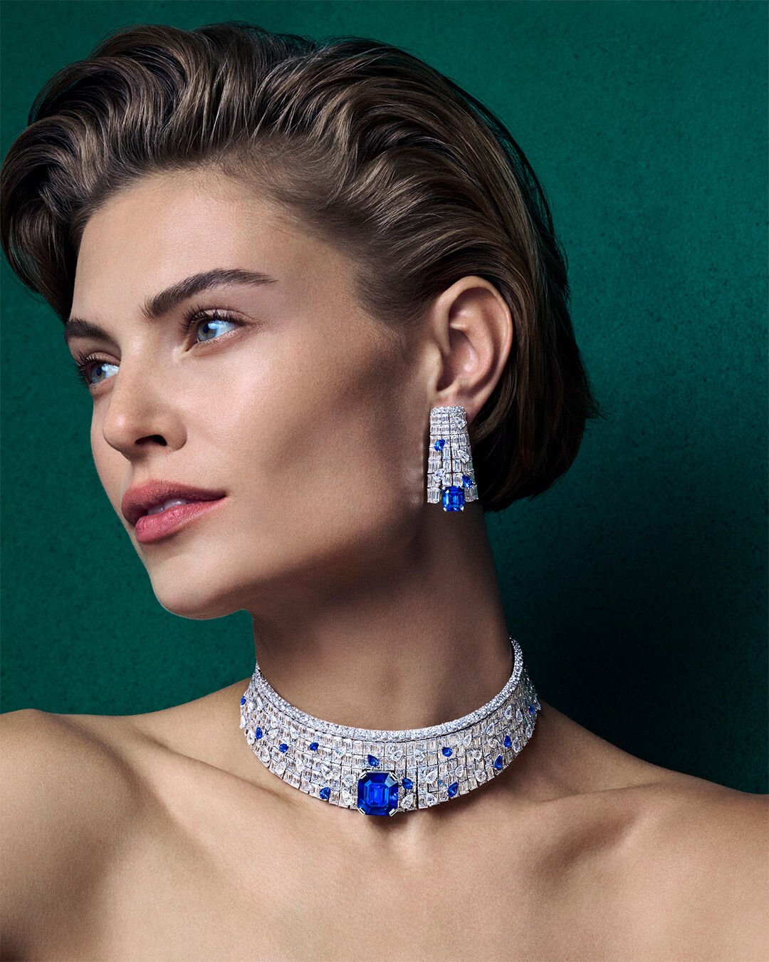 Image shows model wearing Graff high jewellery Sapphire and white diamond suite