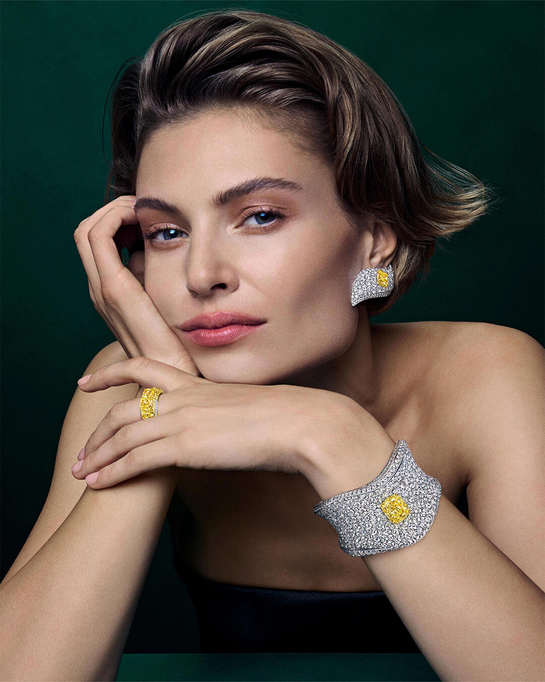 Image of model wearing Graff Yellow Diamond High Jewellery necklace and earrings 