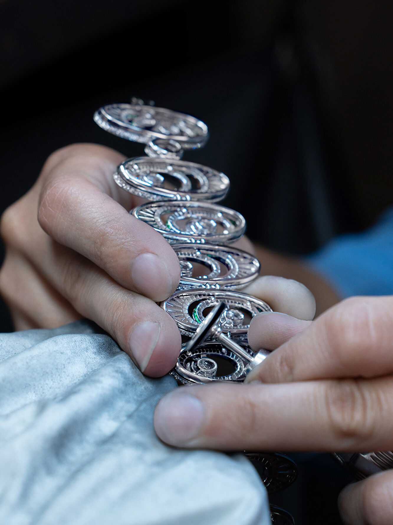 Graff 1963 High Jewellery Suite making of, image shows graff craftsman creating necklace in workshop
