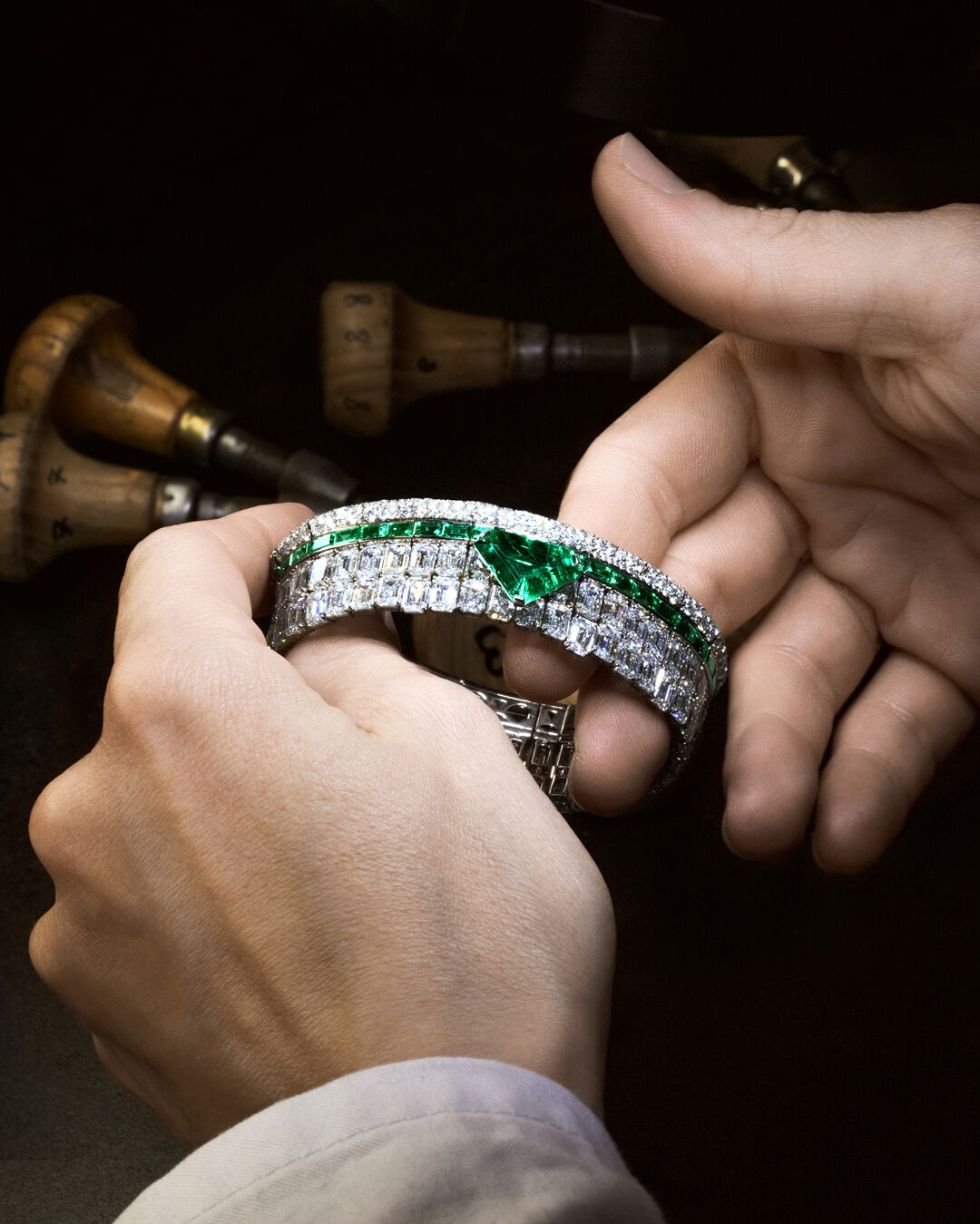 Image shows Graff Emerald and White Diamond High Jewellery bangle being created in Graff workshop