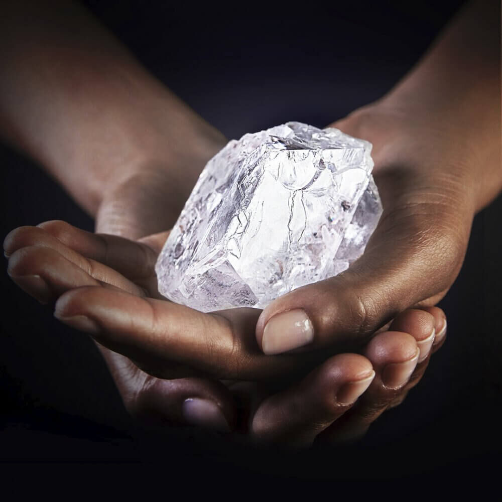 lesedi la rona rough diamond in the hands of model