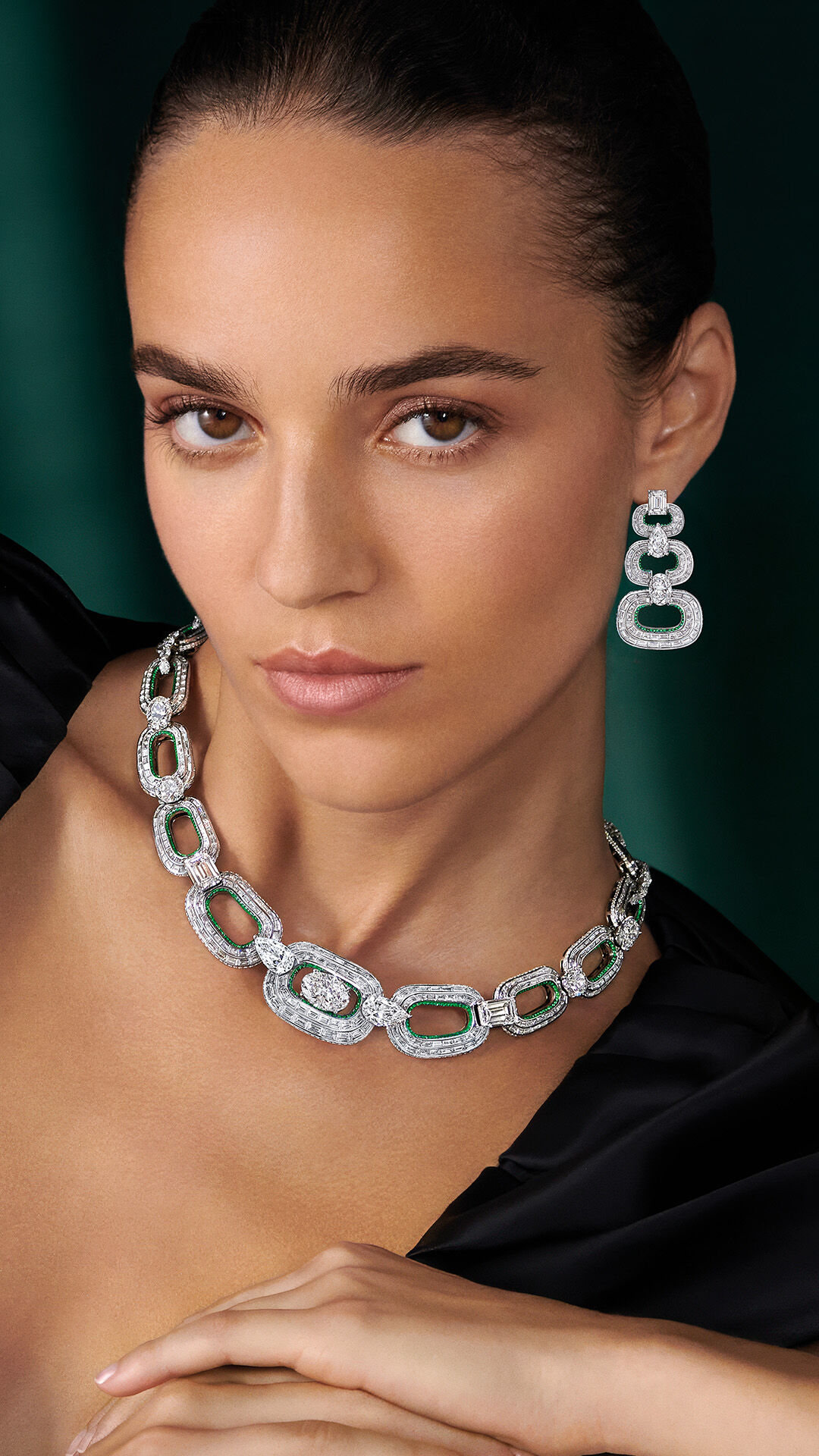 Image shows model wearing Graff White Diamond and Emerald Earrings and Necklace