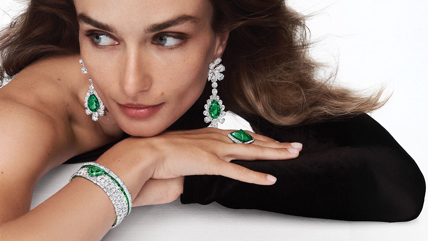 Unique Solitaires - Model wears Graff Emerald High Jewellery suite