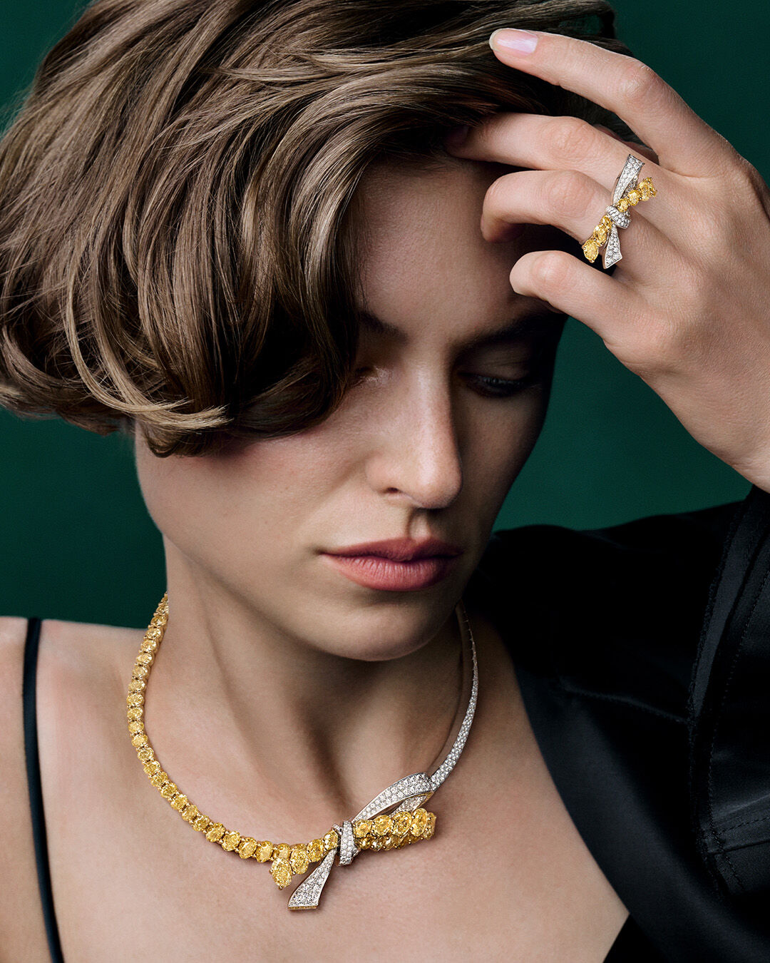 Image shows model wearing Tilda's Bow Yellow Diamond necklace and ring