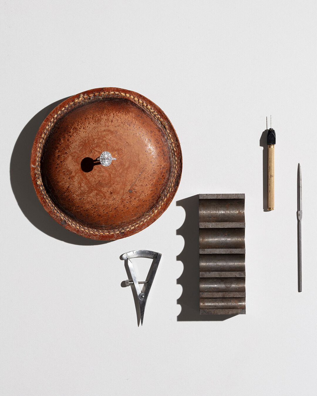 A Guide to Diamond Colour - Image shows Graff Diamond engagement ring and Graff workshop tools.