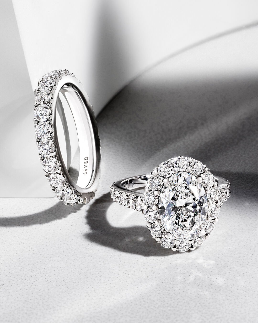 Image shows Graff Oval Diamond engagement ring and Graff round diamond wedding band