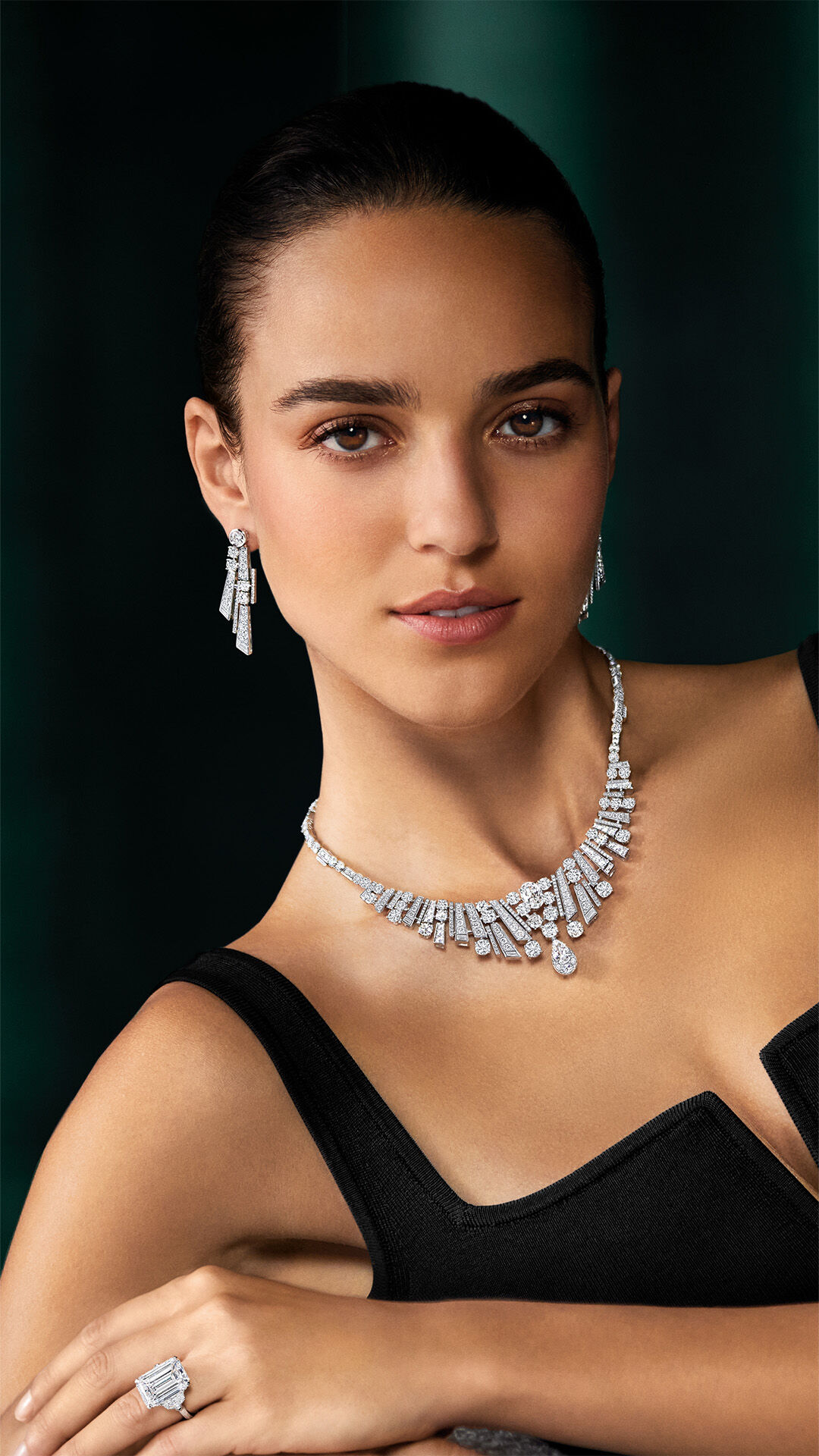Image shows model wearing Graff White Diamond high jewellery necklace and earrings