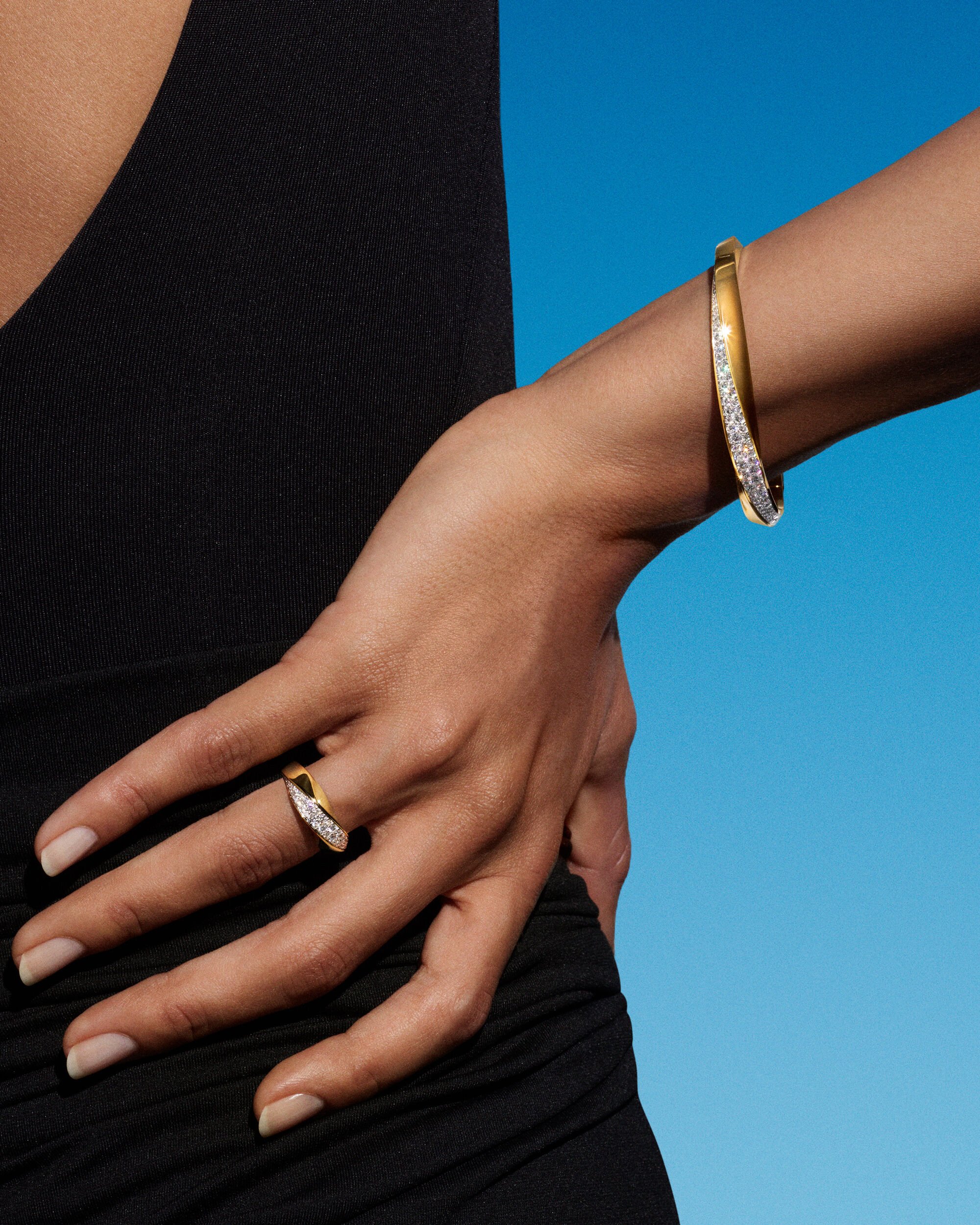 Image shows model hands wearing Spiral collection rings and bangles