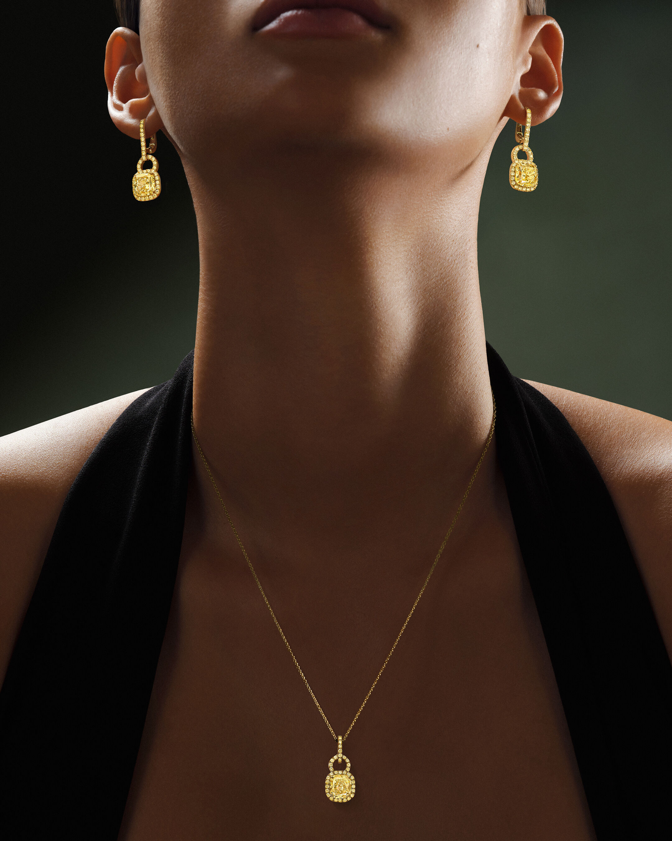 Necklaces and Pendants - image shows model wearing Classic Graff Round, Emerald and Pear cut diamond pendants