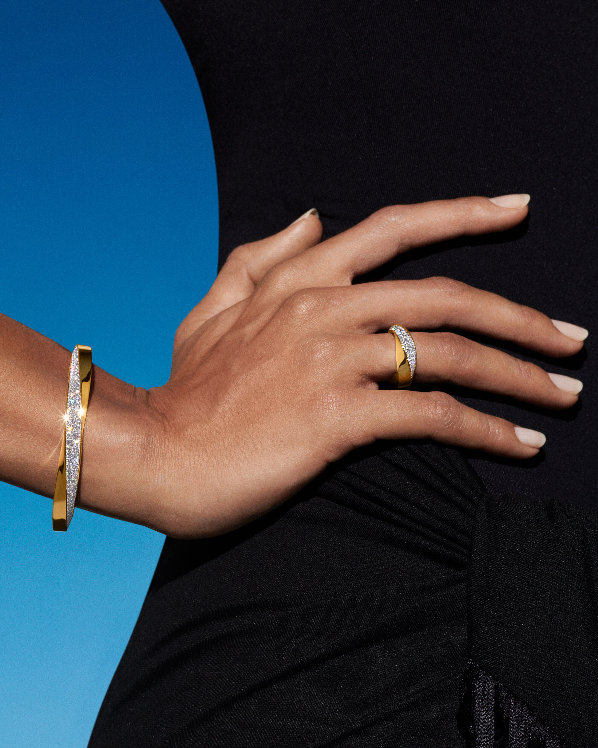 Model wears yellow gold jewellery from the spiral collection