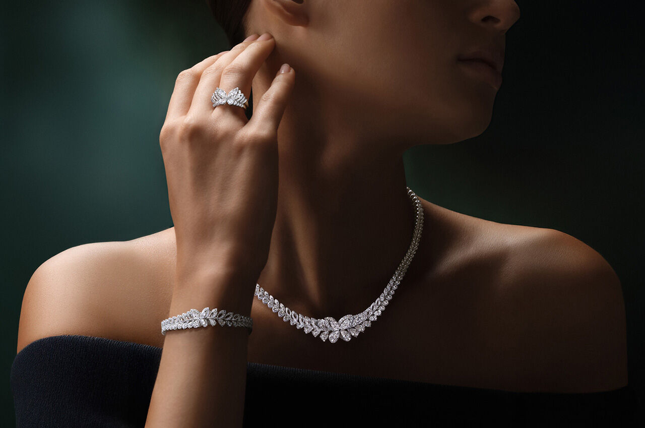 Image shows model wearing Graff Classic Butterfly Necklace, Rings and Bracelet 