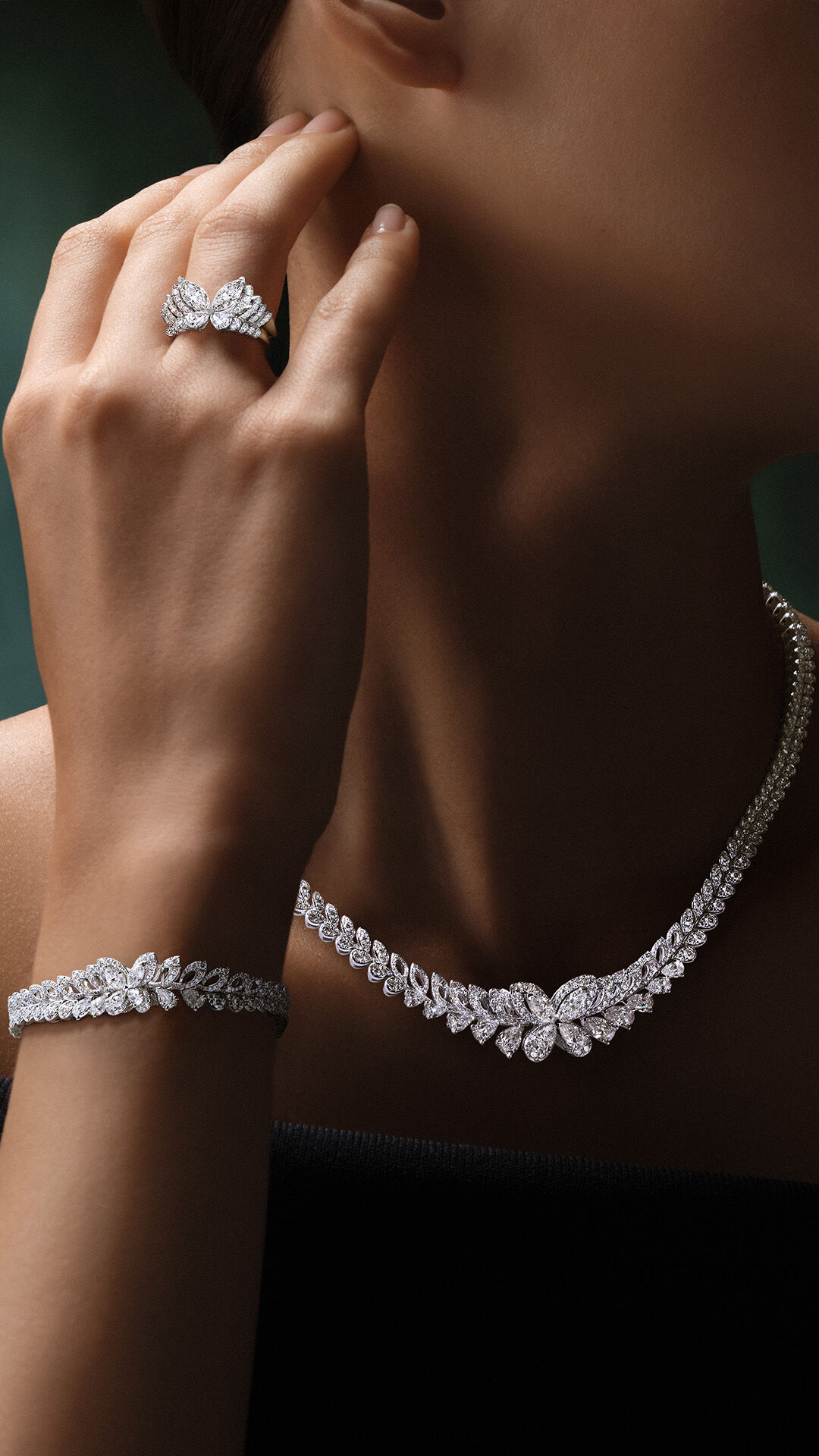 Image shows model wearing Graff Butterfly Necklace, Earrings and Ring