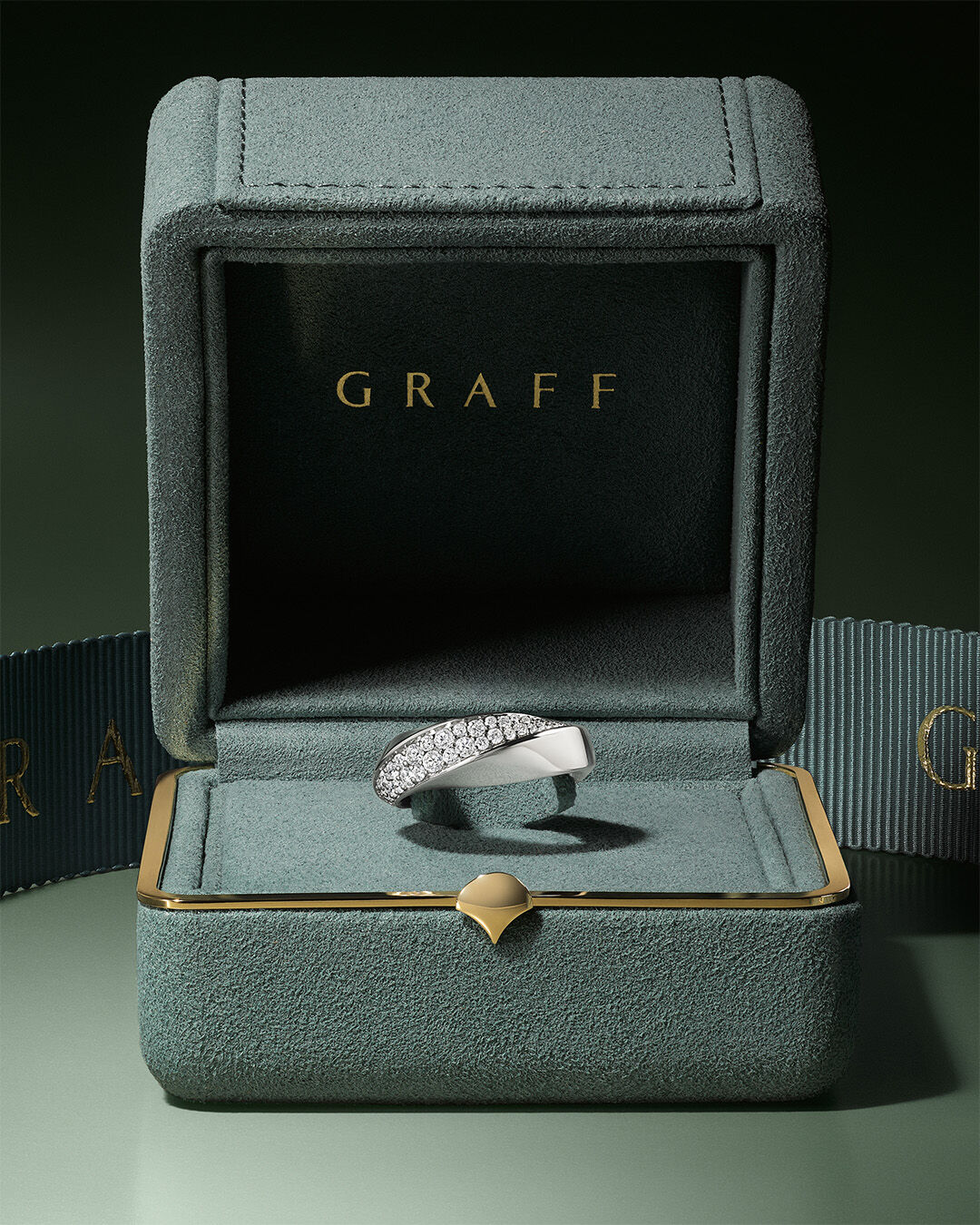 Classic Graff - image shows model hand wearing Emerald cut diamond necklace, eternity ring and engagement ring