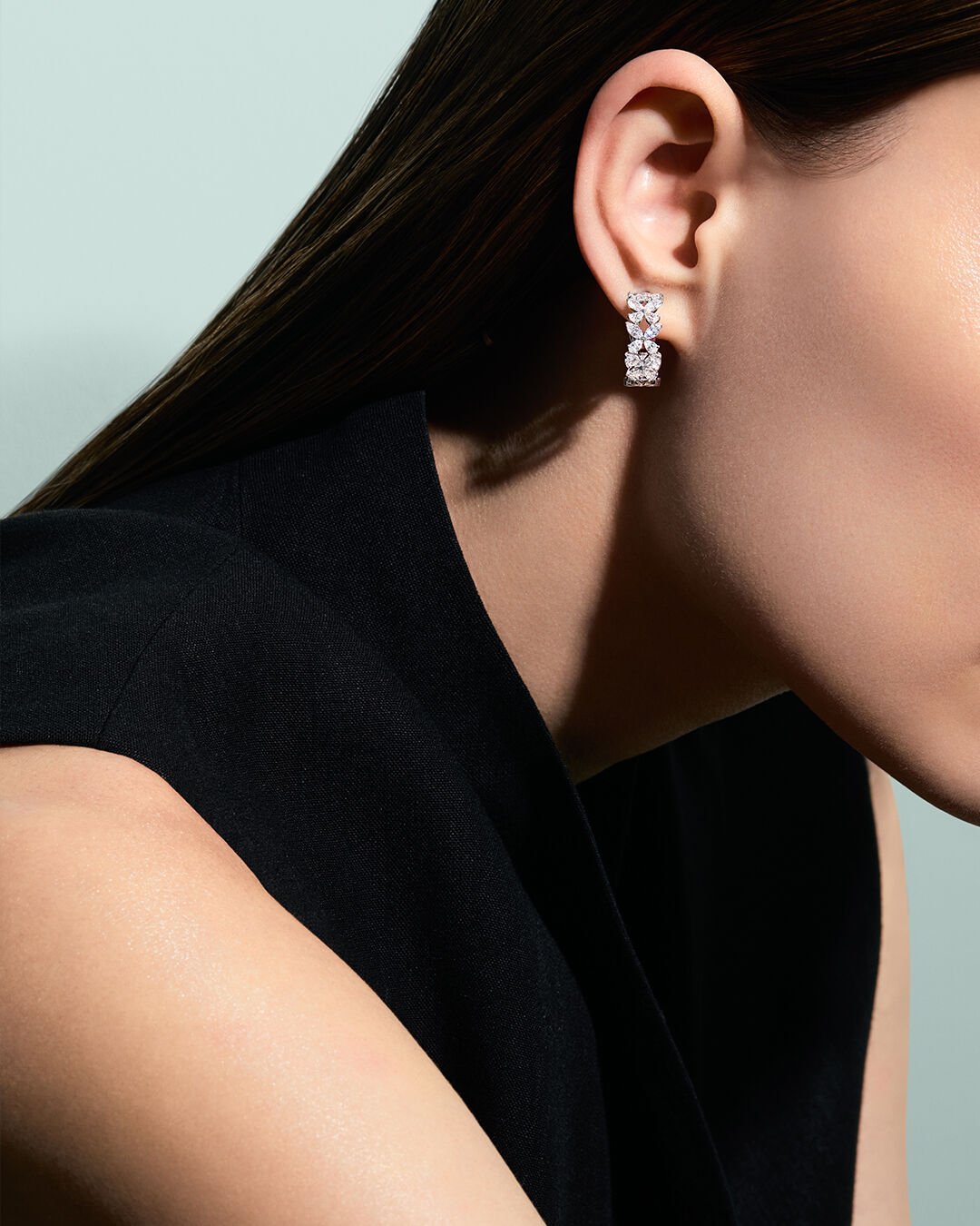 Image shows model wearing Graff Butterfly hoop earrings