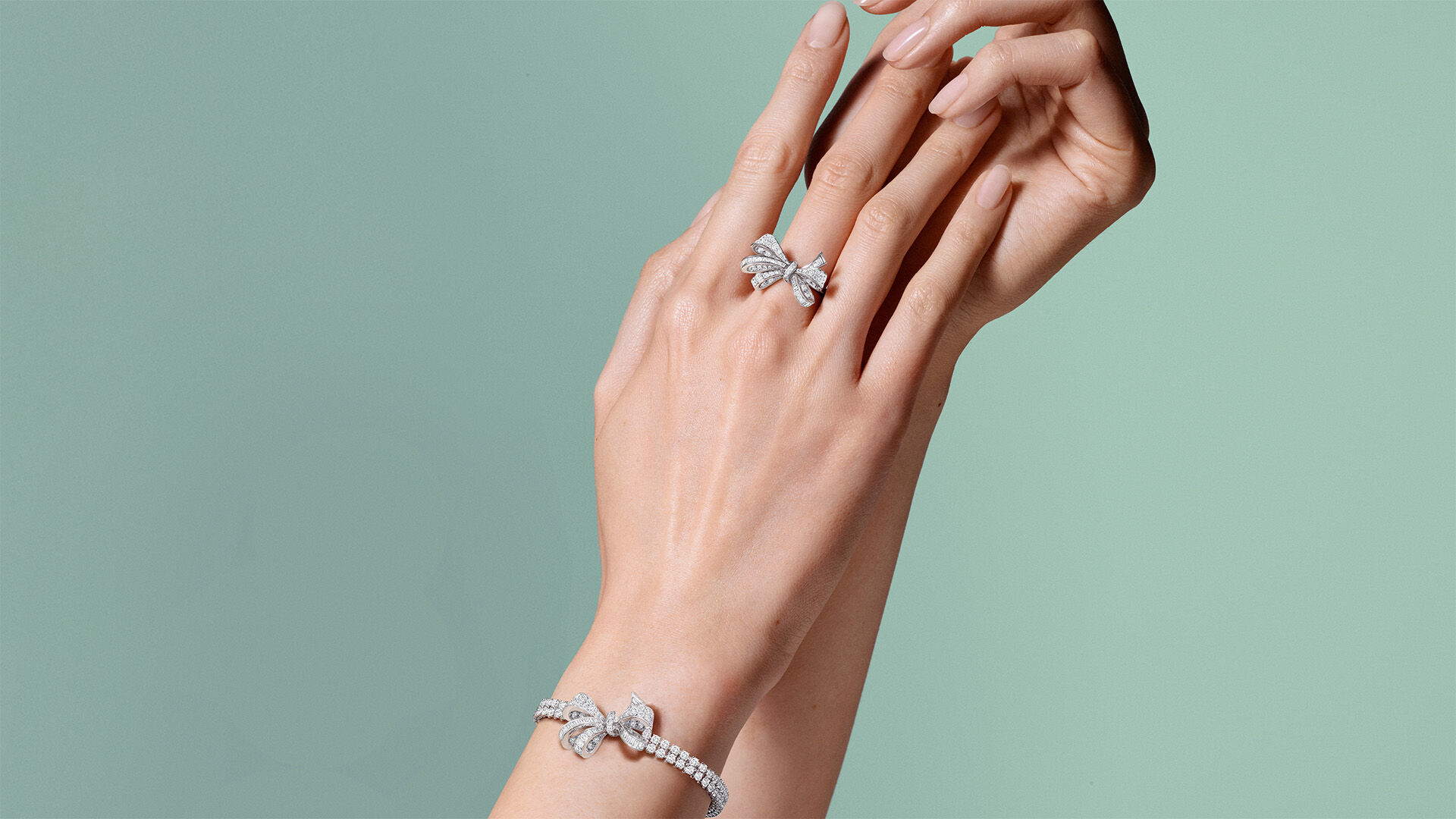 Image of model hands wearing Graff Tilda's Bow ring and bracelet 