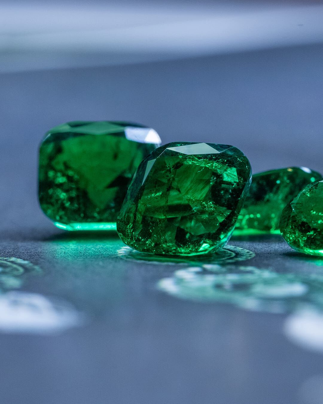 Image of Graff Emerald and White Diamond Solitaire ring being assembled in Graff workshop