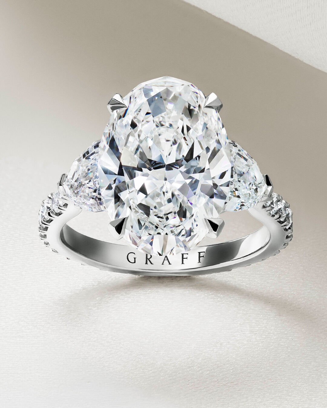 Image shows Graff Oval Diamond engagement ring and Graff round diamond wedding band 