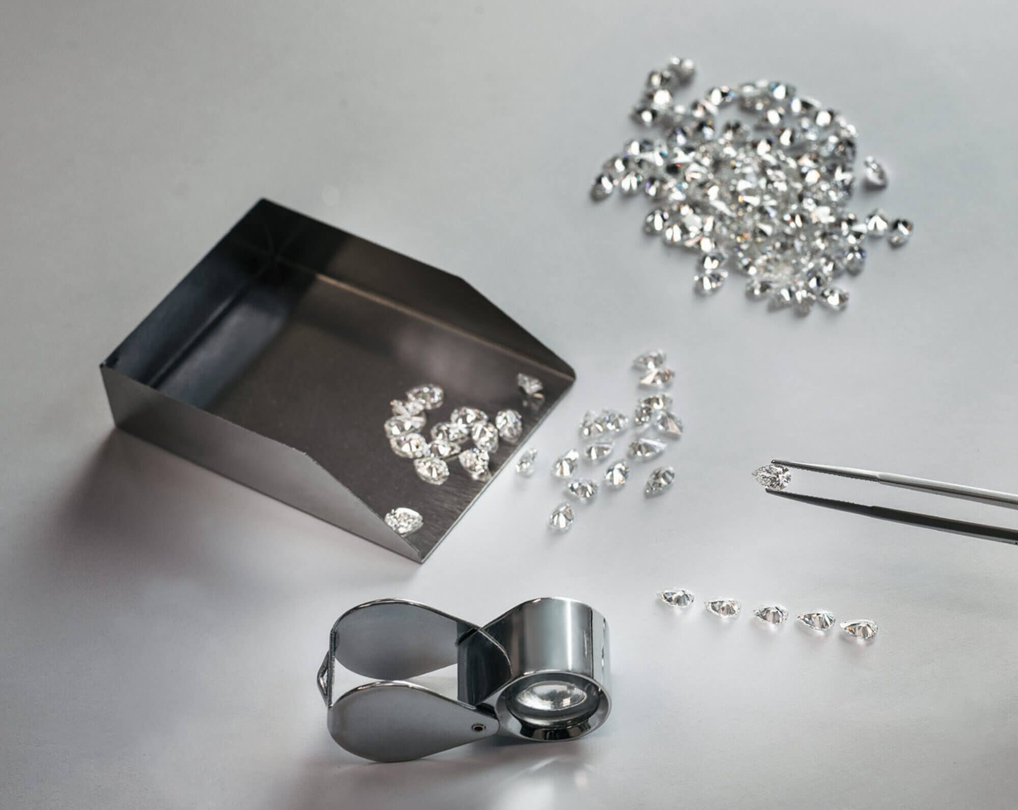 Graff diamond setter lining up diamonds with tools on the table
