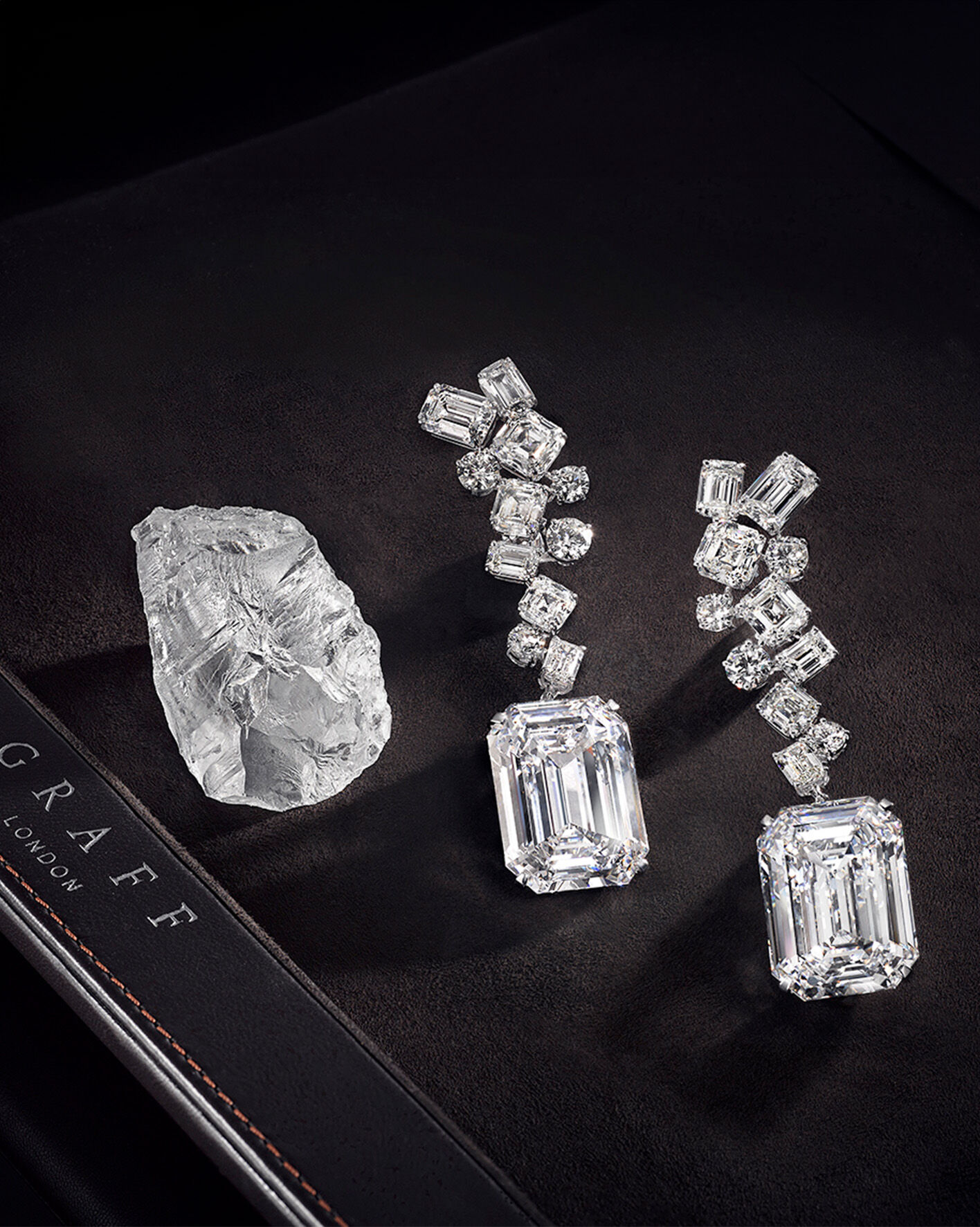 The Graff Eternal Twins - two identical D Flawless emerald cut diamonds weighing 50.23 carats each and the rough stone